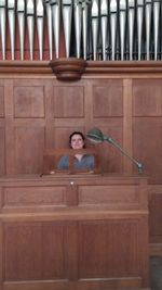 Portrait of a smiling young woman sitting on wood