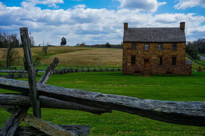 Old building on field against sky