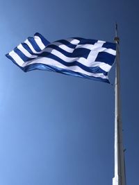 Low angle view of the greek flag against clear blue sky