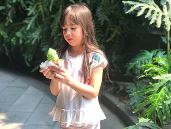 Cute girl holding plant