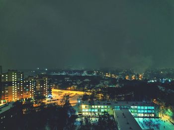 High angle view of illuminated buildings in city at night