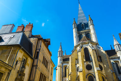 Low angle view of buildings in city against sky