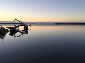 Scenic view of lake against sky during sunset