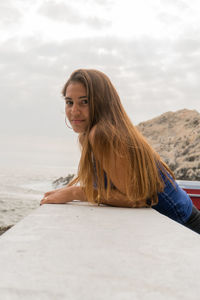 Portrait of woman against sky in sea