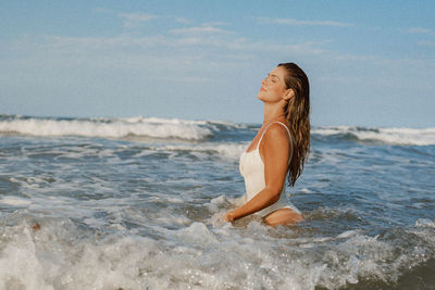 Low section of woman in sea