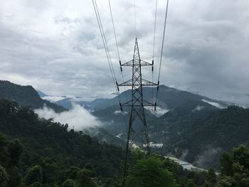 Low angle view of electricity pylon against sky