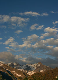 Scenic view of mountains against cloudy sky