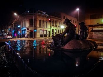 Reflection of illuminated buildings in water at night