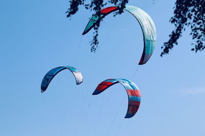 Low angle view of parachutes against sky