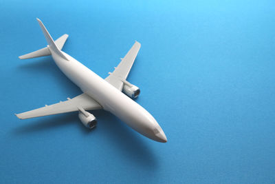 Close-up of model airplane over blue background