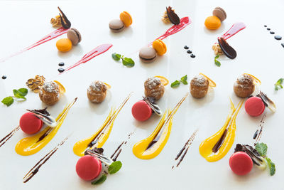 High angle view of multi colored candies against white background