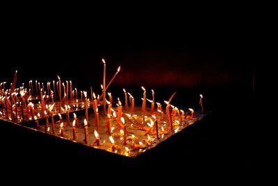 Close-up of illuminated fire against black background