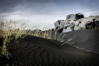 View of sand dunes against sky