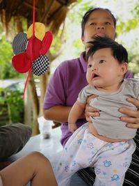 Mother holding cute daughter in park