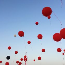 Low angle view of balloons against sky