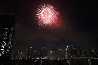 Low angle view of firework display at night