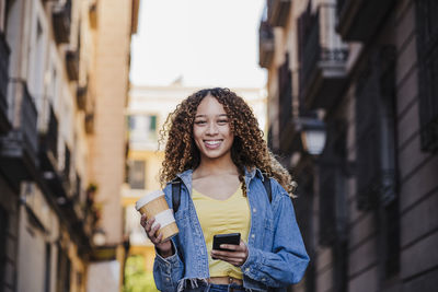 Portrait of a smiling young woman in city