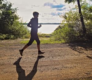 Full length of woman on road during sunny day