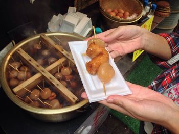 Cropped image of woman having food