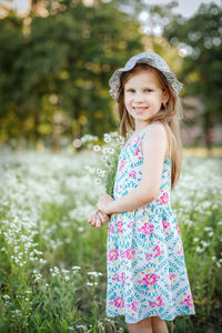 Portrait of smiling girl standing outdoors