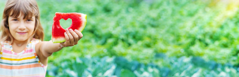 Portrait of cute girl holding flower