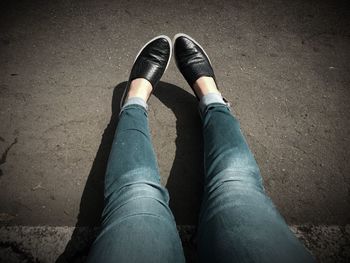 Low section of woman standing on ground