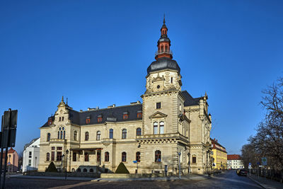 Low angle view of buildings against blue sky