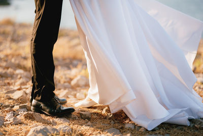 Low section of woman standing on field