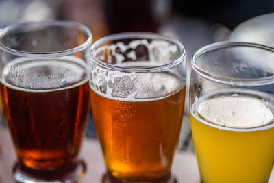 Close-up of beer glasses on table