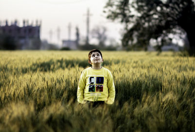 Portrait of woman standing on field