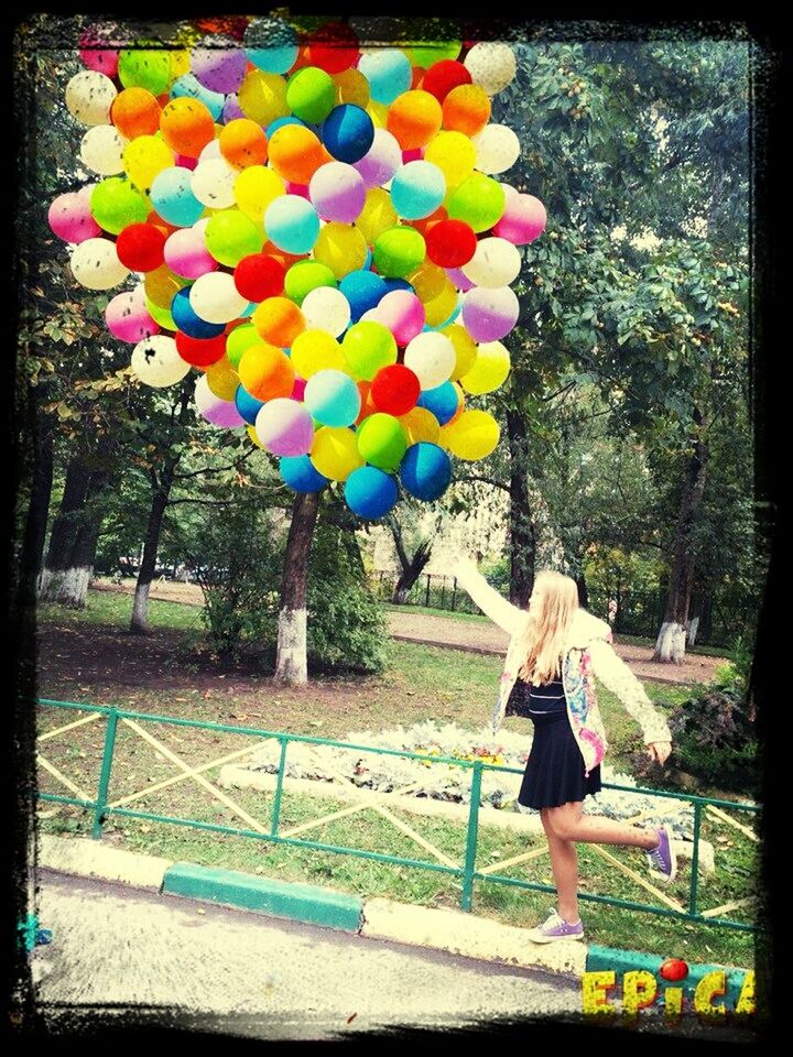 transfer print, multi colored, auto post production filter, umbrella, leisure activity, lifestyles, childhood, colorful, tree, hanging, balloon, rear view, standing, day, outdoors, person, park - man made space, grass