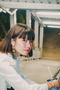 Portrait of young woman reading book