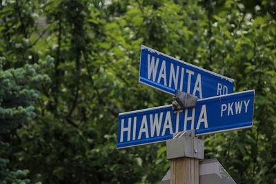 Close-up of road sign against trees