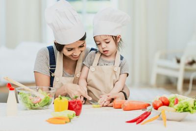 High angle view of girl eating food in kitchen
