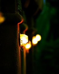 Close-up of illuminated candles at night