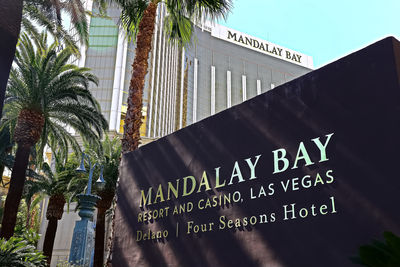 Low angle view of information sign against sky