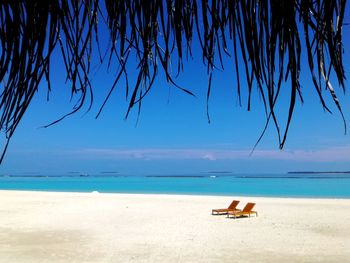 Scenic view of sea against blue sky