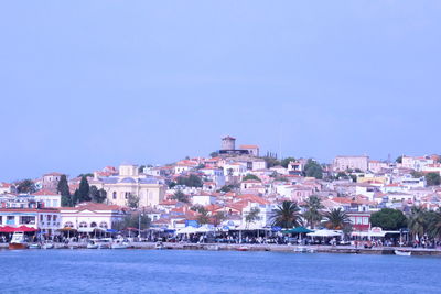 Town by sea against clear sky