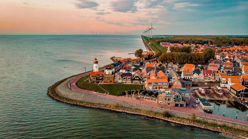 High angle view of townscape by sea against sky