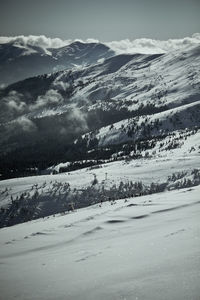 Scenic view of snow covered mountains against sky