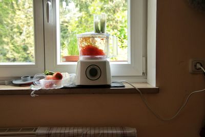 Electric mixer on window at home