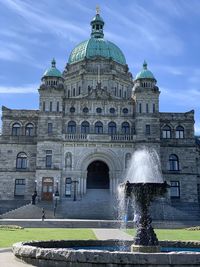 Fountain in front of parliament building against sky in victoria vancouver island 