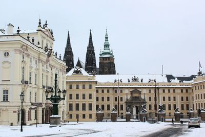 Buildings in city against clear sky during winter