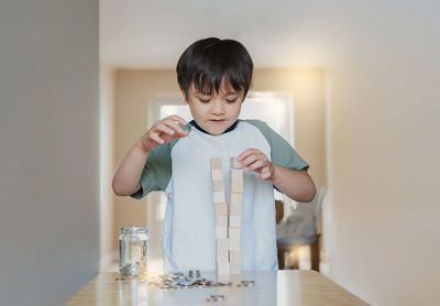 Boy holding table at home