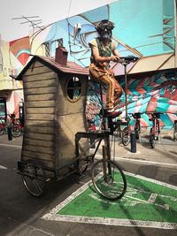 Bicycles on bicycle parked against building