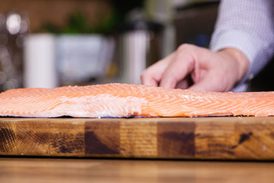 Close-up of person preparing food on cutting board