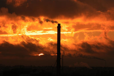 Silhouette of tree against cloudy sky