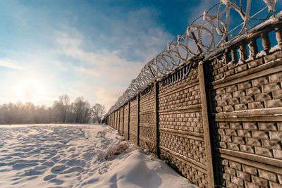 Snow covered landscape against sky