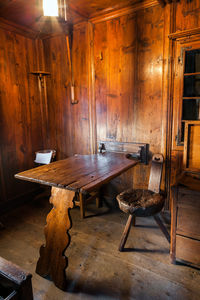 Old wooden chairs and tables in building