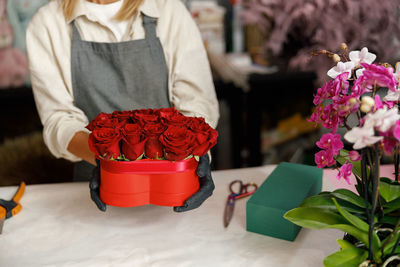 Midsection of woman holding bouquet